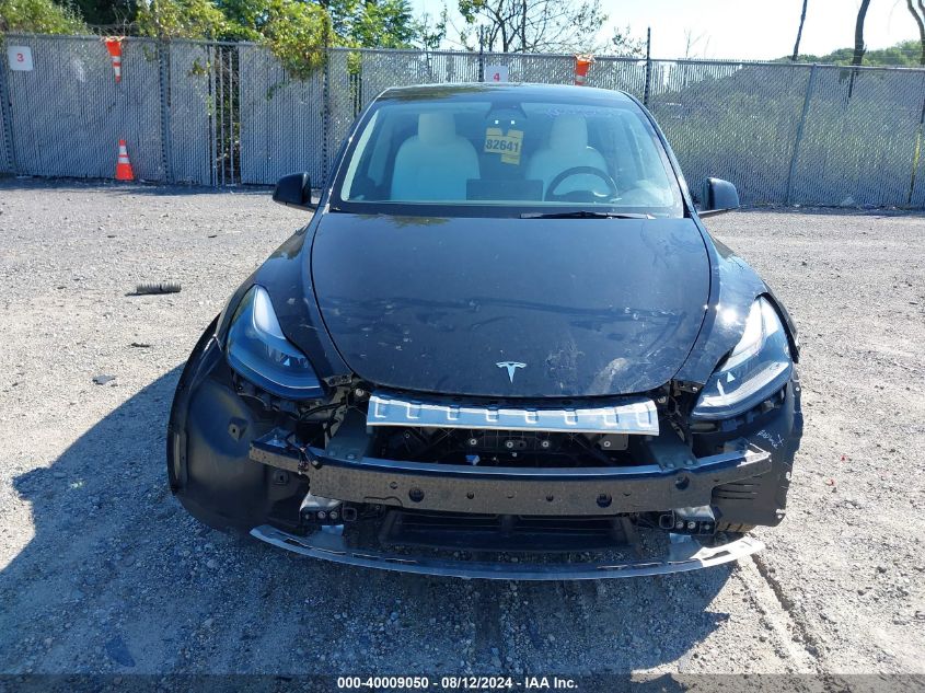 2023 Tesla Model Y Awd/Long Range Dual Motor All-Wheel Drive VIN: 7SAYGDEE8PF630521 Lot: 40009050