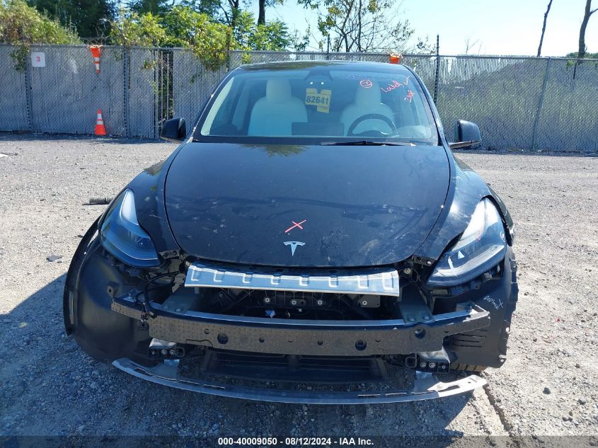 2023 Tesla Model Y Awd/Long Range Dual Motor All-Wheel Drive VIN: 7SAYGDEE8PF630521 Lot: 40009050