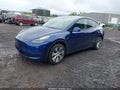 2023 Tesla Model Y — photo 2 of 18 | VIN 7SAYGDEE0PF770305