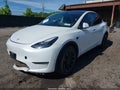 2023 Tesla Model Y — photo 2 of 15 | VIN 7SAYGDED1PF915696