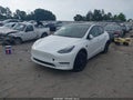 2023 Tesla Model Y — photo 2 of 15 | VIN 7SAYGAEE7PF695858