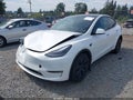 2025 Tesla Model Y — photo 2 of 21 | VIN 7SAYGDEE4SF284279