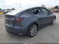 2023 Tesla Model Y — photo 4 of 18 | VIN 7SAYGAEE9PF904193