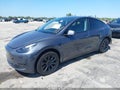 2023 Tesla Model Y — photo 2 of 16 | VIN 7SAYGDED4PF949695