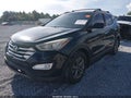 2015 Hyundai Santa Fe — photo 2 of 16 | VIN 5XYZU3LB4FG277750