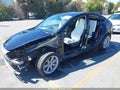 2023 Tesla Model Y — photo 2 of 23 | VIN 7SAYGAEEXPF838222