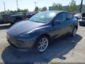 2023 Tesla Model Y — photo 2 of 20 | VIN 7SAYGDEE6PF902757