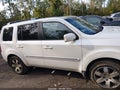 2014 Honda Pilot — photo 13 of 16 | VIN 5FNYF4H98EB022025