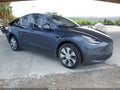 2023 Tesla Model Y — photo 1 of 15 | VIN 7SAYGDEE6PA176248