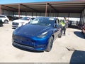 2023 Tesla Model Y — photo 2 of 14 | VIN 7SAYGAEEXPF912920