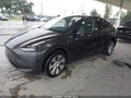 2024 Tesla Model Y — photo 2 of 21 | VIN 7SAYGDED5RF039802