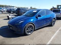 2025 Tesla Model Y — photo 2 of 14 | VIN 7SAYGAEE2SF296638